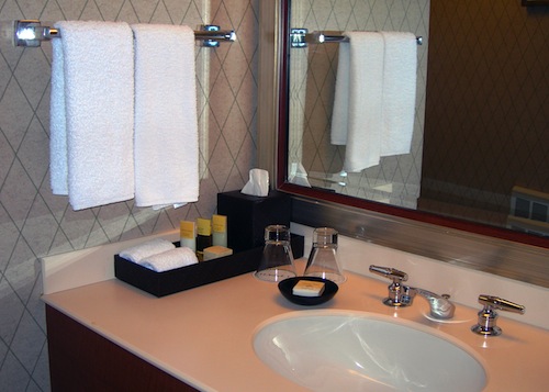 Extra towel racks and vanity storage containers can add extra storage to a small space.